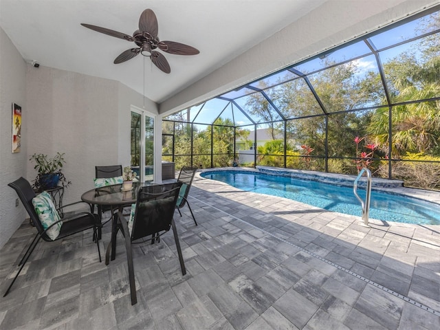 pool featuring a ceiling fan, a patio area, and glass enclosure