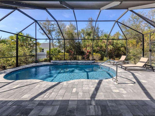 outdoor pool featuring glass enclosure and a patio area