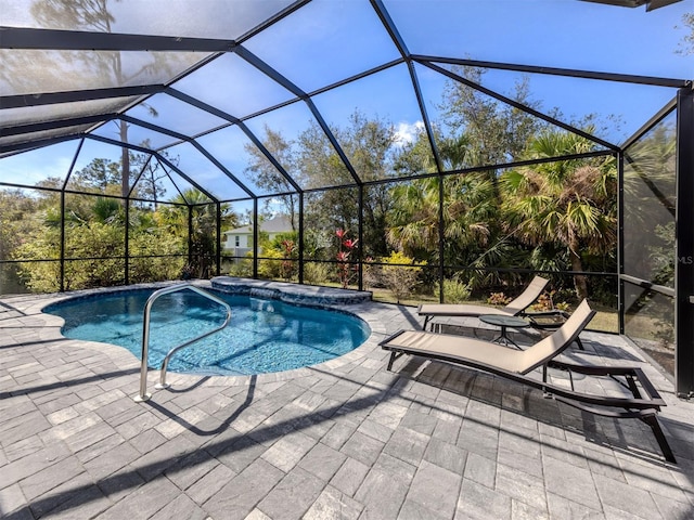 outdoor pool featuring a lanai and a patio area