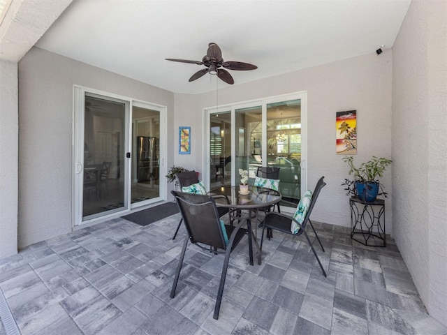 view of patio featuring outdoor dining space and a ceiling fan