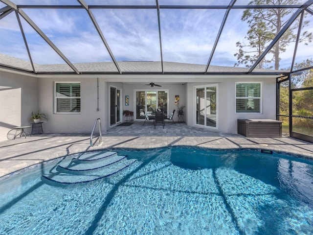 outdoor pool with a patio, a lanai, and a ceiling fan