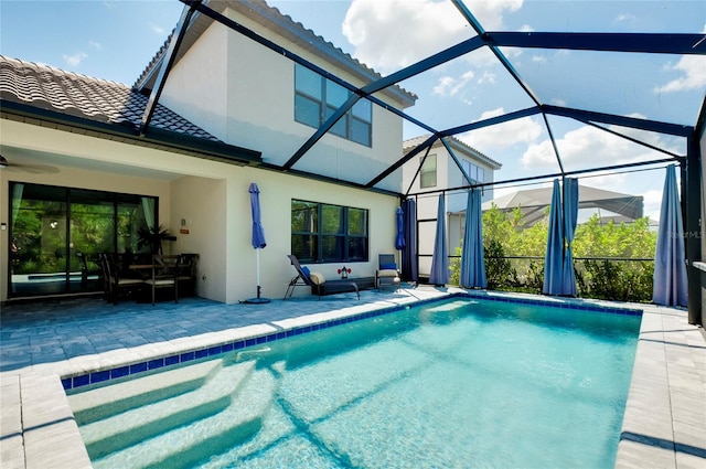 pool featuring a lanai, ceiling fan, and a patio