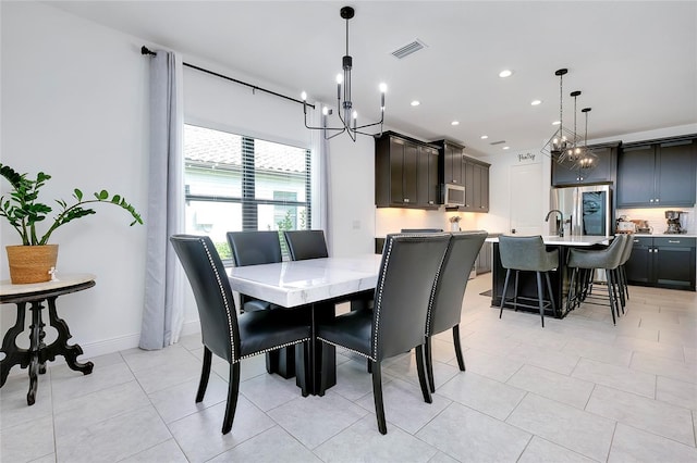 dining room with a chandelier, light tile patterned flooring, recessed lighting, visible vents, and baseboards