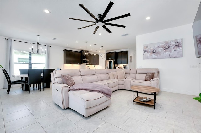 living area featuring light tile patterned flooring, baseboards, visible vents, and recessed lighting