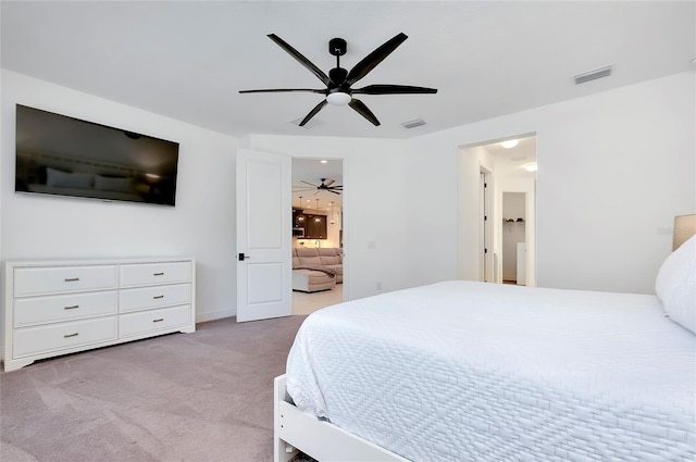 carpeted bedroom with visible vents and a ceiling fan