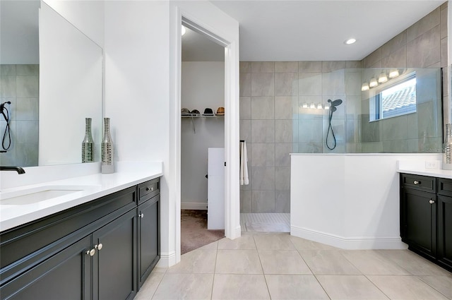 full bathroom with tile patterned floors, vanity, and walk in shower