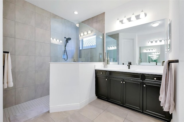 bathroom featuring tile patterned flooring, walk in shower, and vanity