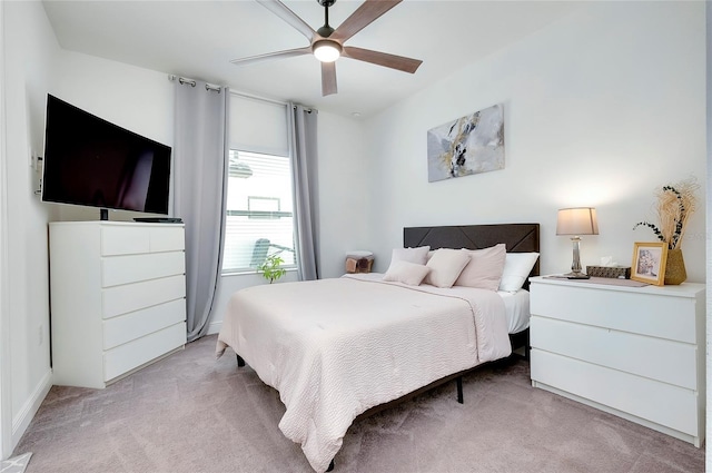 bedroom with a ceiling fan and light carpet