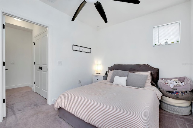 bedroom featuring light carpet, ceiling fan, and baseboards