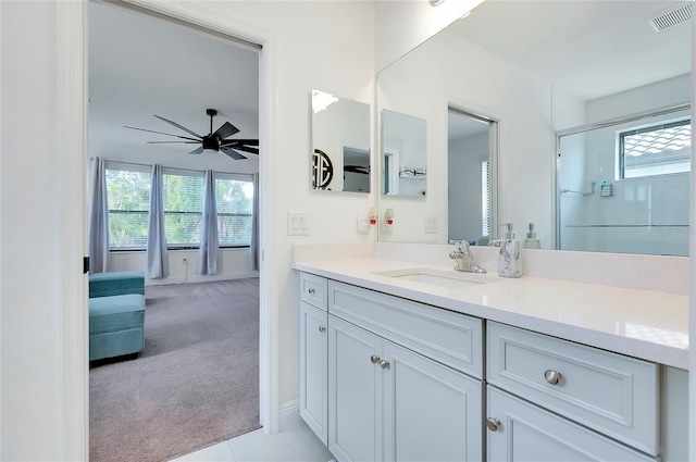 full bathroom featuring ensuite bathroom, vanity, visible vents, a ceiling fan, and an enclosed shower