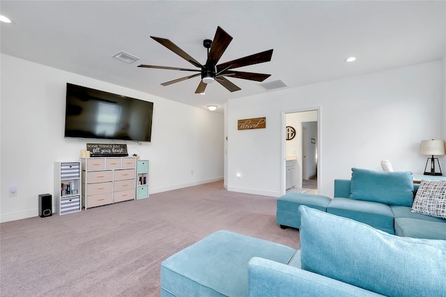 living area featuring a ceiling fan, light colored carpet, visible vents, and baseboards