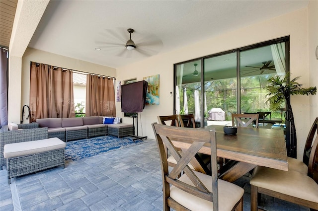 dining area featuring stone finish floor and ceiling fan