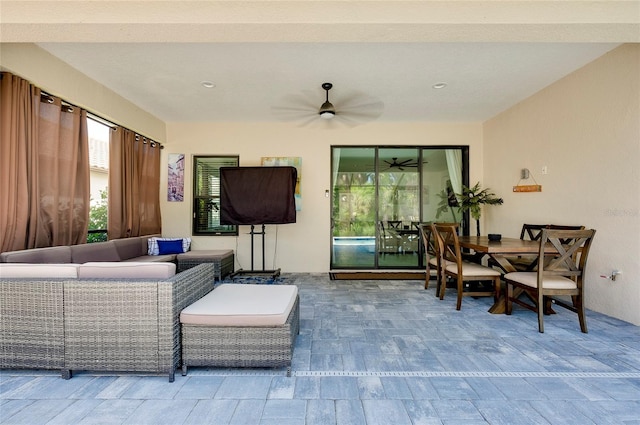 view of patio / terrace featuring an outdoor living space, a ceiling fan, and outdoor dining space