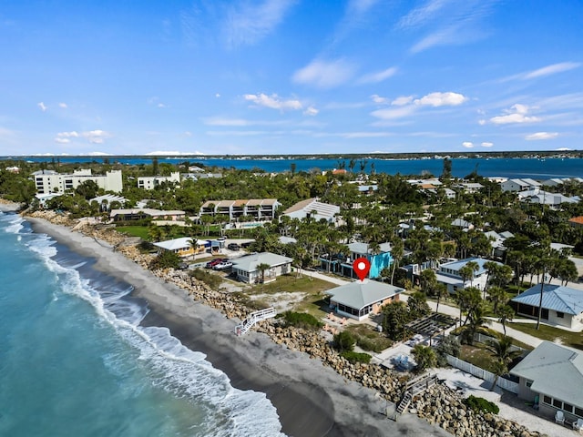 drone / aerial view with a residential view, a water view, and a beach view