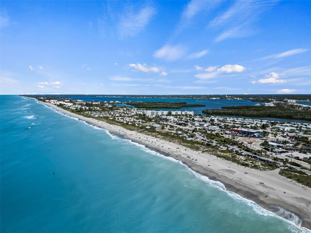 aerial view featuring a view of the beach and a water view