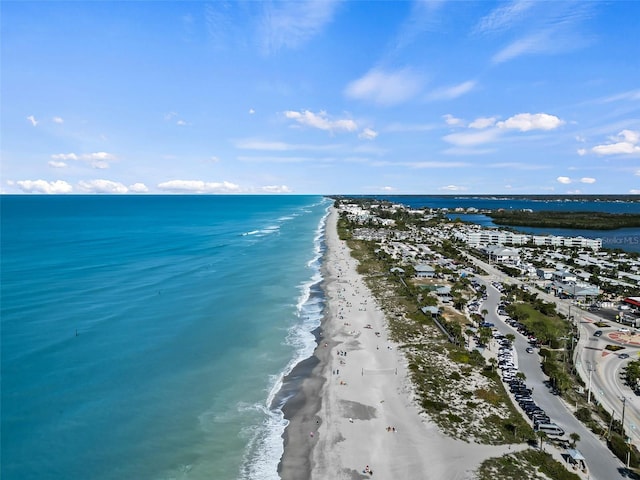 birds eye view of property with a water view and a beach view