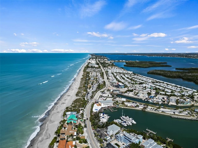 aerial view with a water view and a beach view