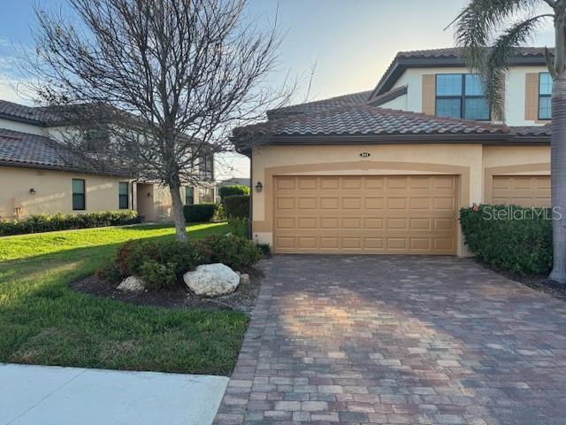 view of front of property with a garage and a front yard