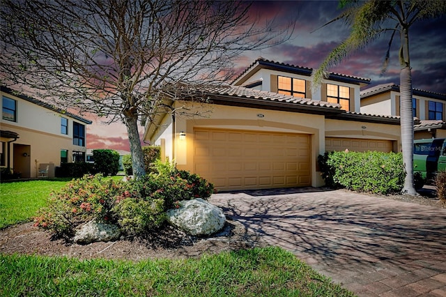 mediterranean / spanish-style house with a garage