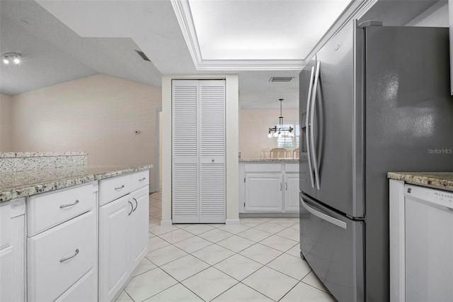 1915 Pebble Beach Ct, Venice, FL 34293 - kitchen featuring freestanding refrigerator, dishwasher, white cabinets, light tile patterned flooring, and light stone counters