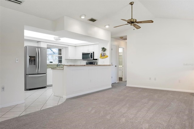 1915 Pebble Beach Ct, Venice, FL 34293 - kitchen featuring appliances with stainless steel finishes, white cabinetry, vaulted ceiling, ceiling fan, and baseboards