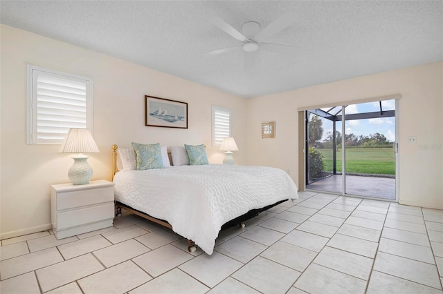 1915 Pebble Beach Ct, Venice, FL 34293 - bedroom featuring access to outside, a textured ceiling, a ceiling fan, light tile patterned flooring, and baseboards