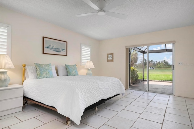 1915 Pebble Beach Ct, Venice, FL 34293 - bedroom featuring access to outside, a textured ceiling, multiple windows, light tile patterned flooring, and ceiling fan