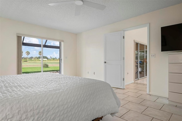 1915 Pebble Beach Ct, Venice, FL 34293 - bedroom featuring access to exterior, a textured ceiling, and a ceiling fan