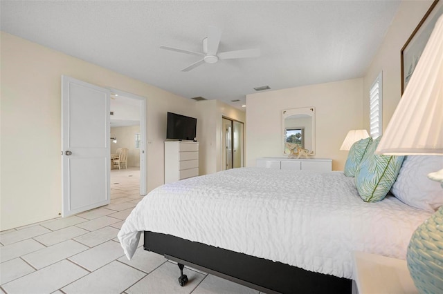1915 Pebble Beach Ct, Venice, FL 34293 - bedroom with light tile patterned floors, a closet, and a ceiling fan