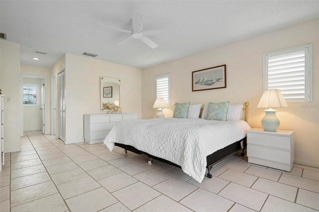 1915 Pebble Beach Ct, Venice, FL 34293 - bedroom with a closet, multiple windows, and light tile patterned floors