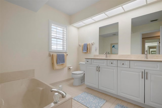 1915 Pebble Beach Ct, Venice, FL 34293 - bathroom featuring double vanity, toilet, a bath, tile patterned floors, and baseboards