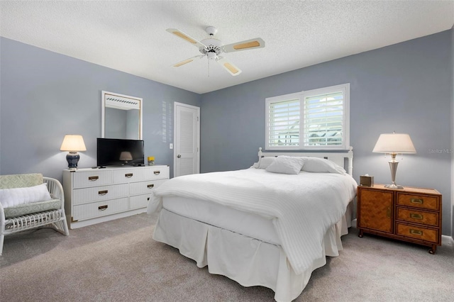 1915 Pebble Beach Ct, Venice, FL 34293 - bedroom with light carpet, a textured ceiling, and ceiling fan