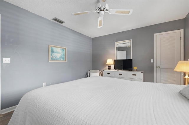 1915 Pebble Beach Ct, Venice, FL 34293 - bedroom with ceiling fan, wood finished floors, and baseboards