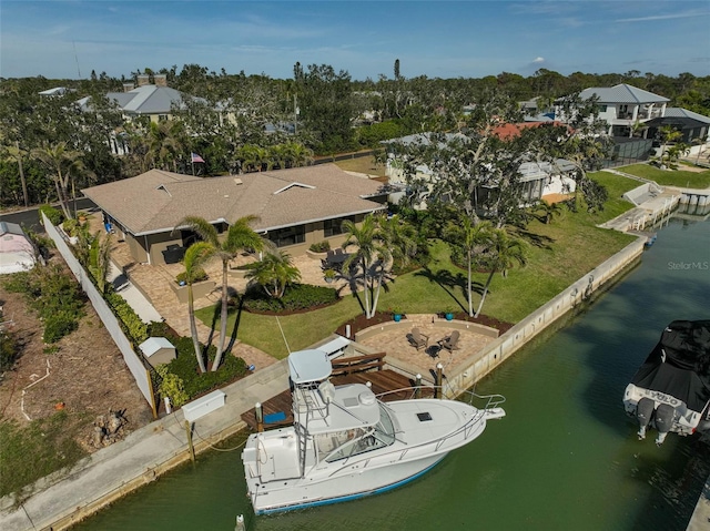 drone / aerial view with a residential view and a water view