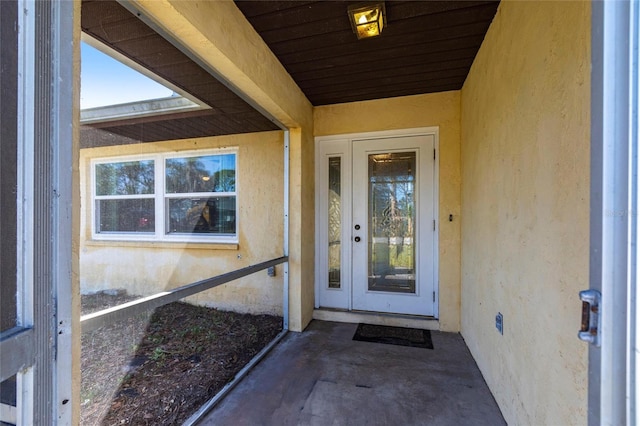 property entrance with stucco siding