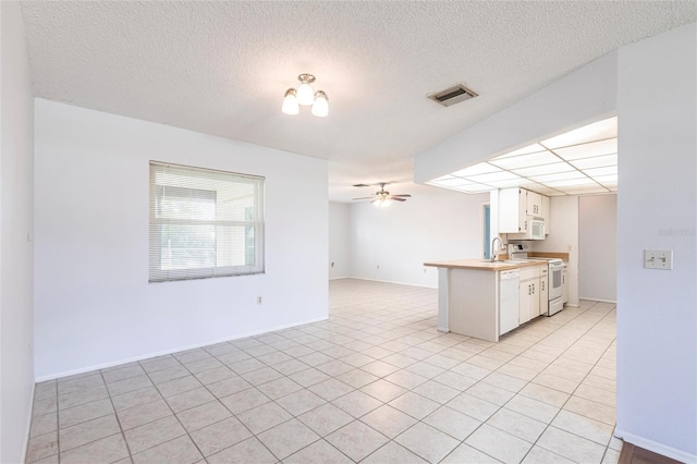 kitchen featuring ceiling fan, white appliances, visible vents, white cabinetry, and open floor plan