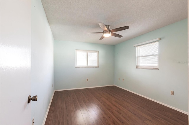 unfurnished room with a textured ceiling, ceiling fan, wood finished floors, and baseboards