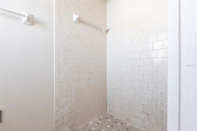 full bath featuring a tile shower