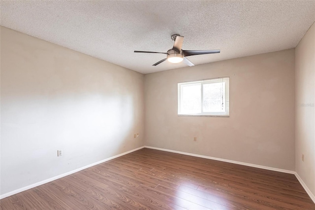 unfurnished room with a ceiling fan, a textured ceiling, baseboards, and wood finished floors