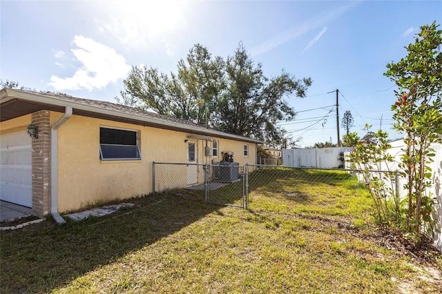 view of yard with a garage and fence