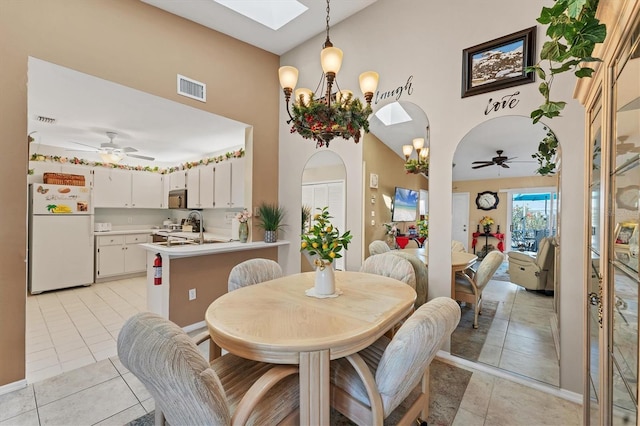 3300 Loveland Blvd Unit 1201, Punta Gorda, FL 33980 - dining area featuring light tile patterned floors, visible vents, arched walkways, and ceiling fan with notable chandelier