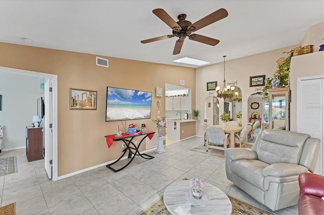 3300 Loveland Blvd Unit 1201, Punta Gorda, FL 33980 - living area with light tile patterned floors, baseboards, visible vents, arched walkways, and ceiling fan with notable chandelier