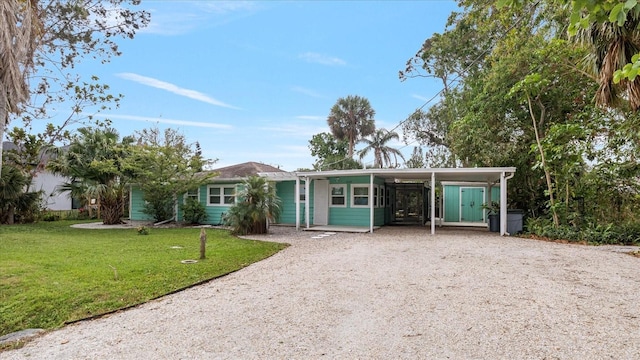 view of front facade with a front yard and a carport