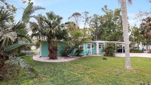 view of front of house with a front lawn and a carport