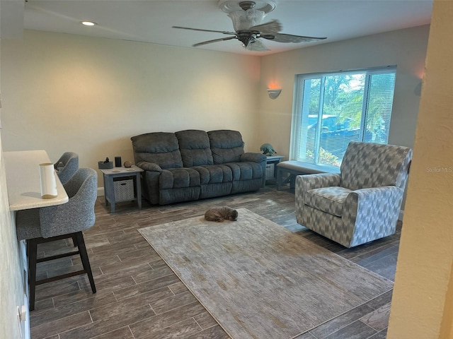 living area with ceiling fan and wood finish floors