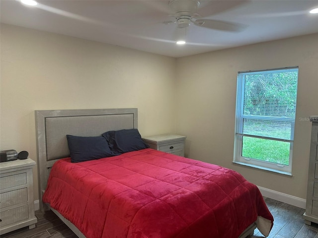 bedroom with multiple windows, dark wood-style flooring, recessed lighting, and baseboards