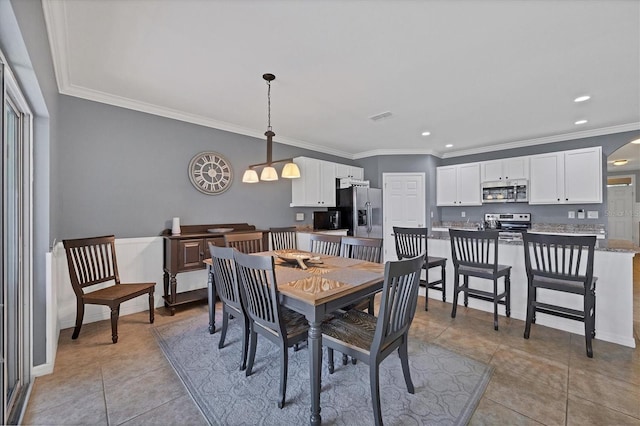 dining space with light tile patterned floors and crown molding