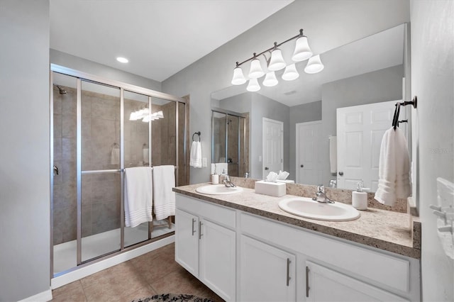 bathroom with tile patterned flooring, vanity, and walk in shower