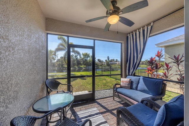 sunroom with ceiling fan