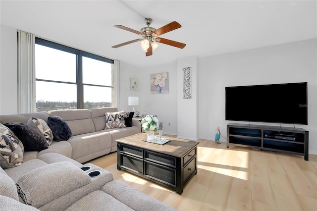 living room featuring ceiling fan and light hardwood / wood-style flooring